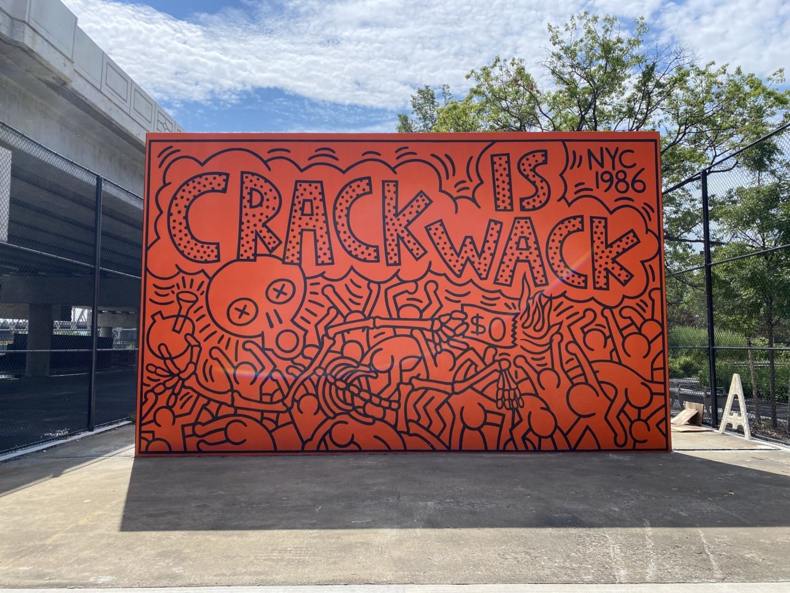 Keith Haring’s Crack is Wack mural from 1986, featuring bold line art and anti-drug message on a handball court in New York City.