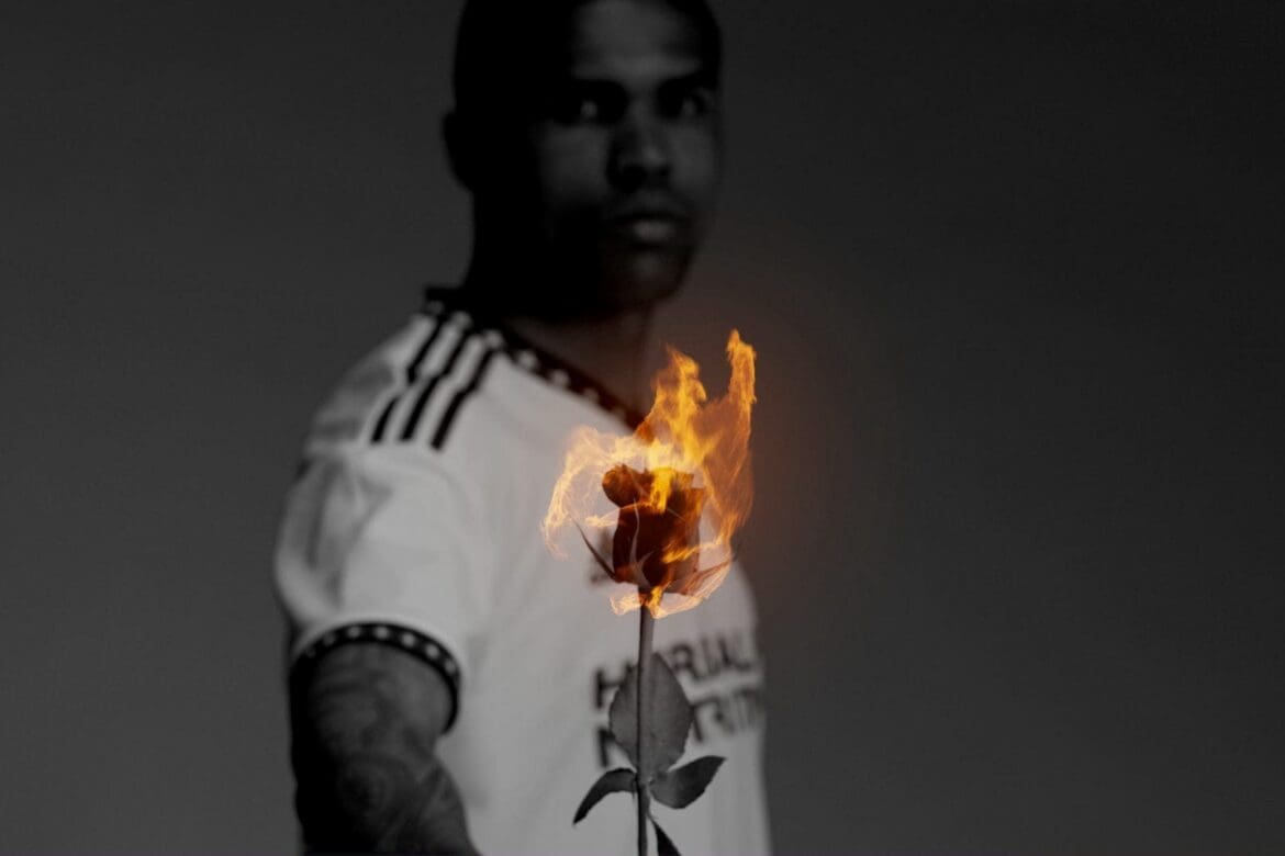 Douglas Costa of LA Galaxy holding a flaming rose, representing the passion and intensity of the Rose Bowl Stadium campaign.