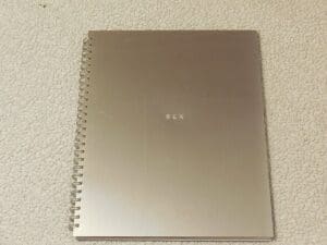 Spiral-bound metallic cover of Madonna’s 1992 Sex book with the word “SEX” stamped in small type.