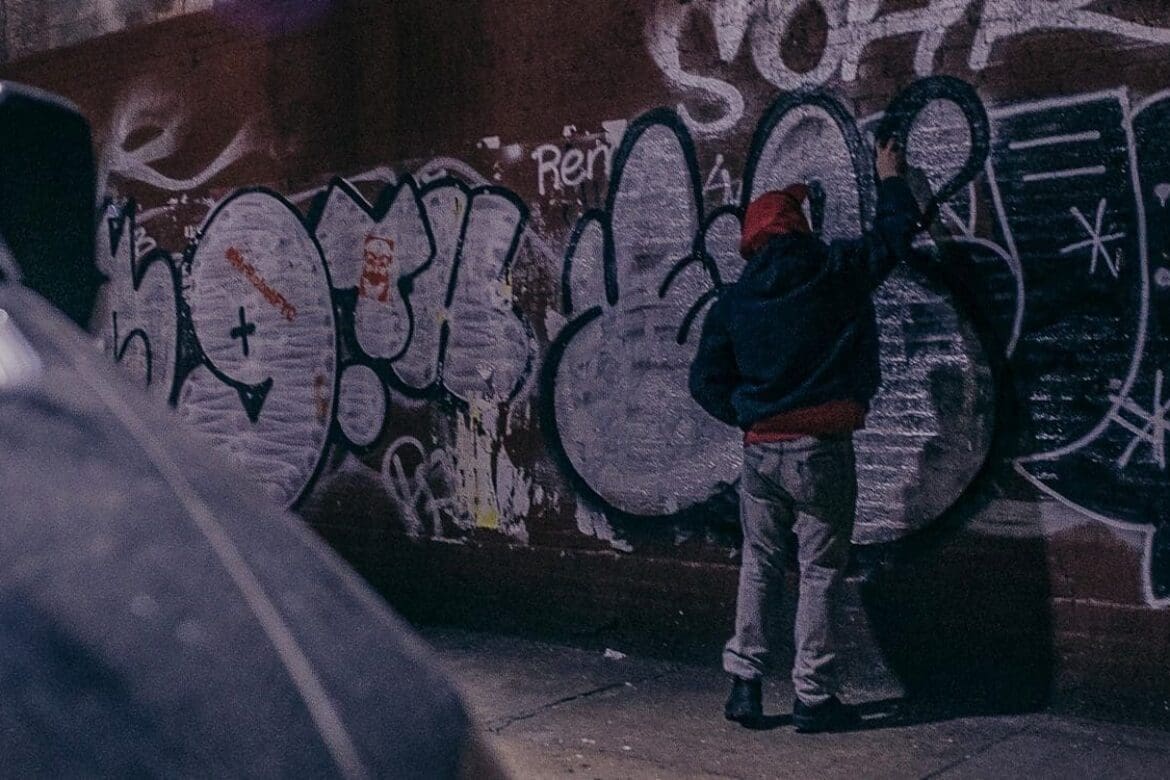 Photo of a man doing graffiti on the streets of NYC taken by creative agency founder MUG5