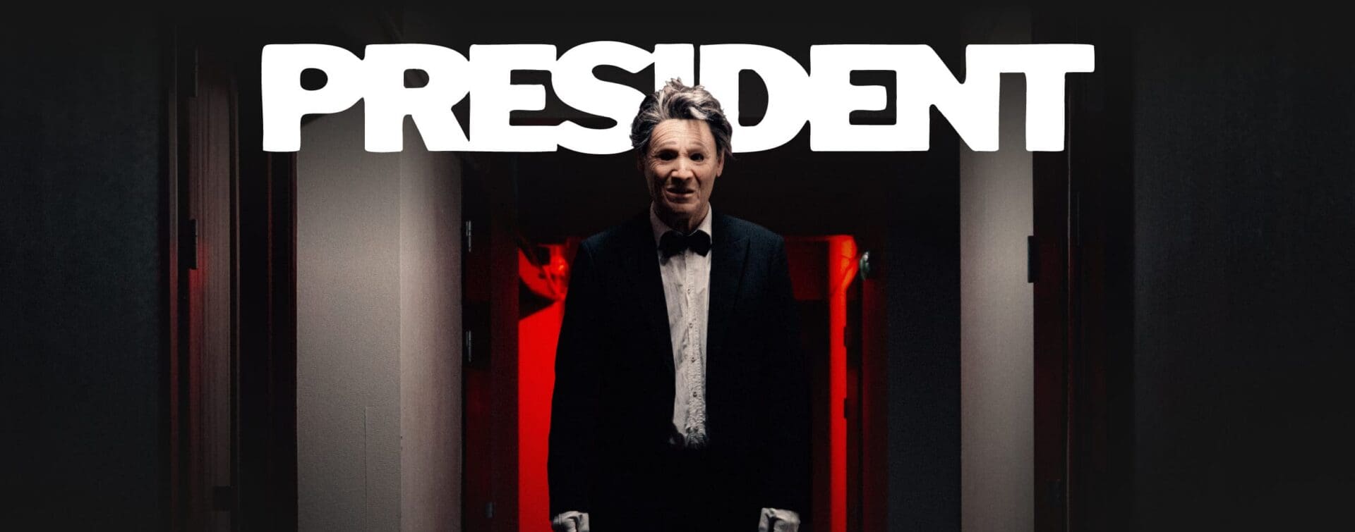 Promotional image of masked band President. A figure in a tuxedo with white gloves stands in a dimly lit hallway with red lighting behind them, beneath the bold PRESIDENT logo.