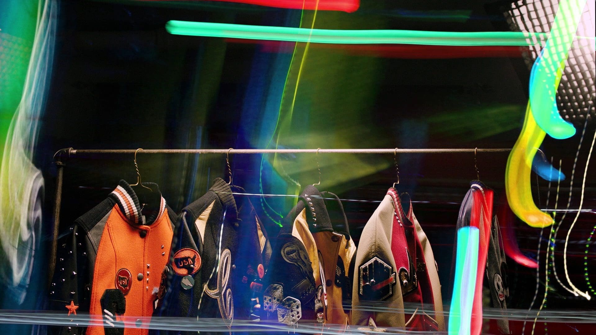 RIOT, NYC Creative Agency: Coach Varsity jackets from the Women’s Fall 2016 collection displayed on a rack with neon graffiti-inspired lighting effects. Coach Varsity jackets from the Women’s Fall 2016 collection displayed on a rack with neon graffiti-inspired lighting effects.