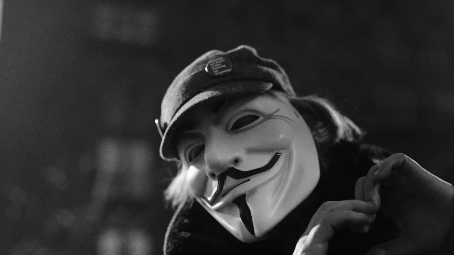 RIOT, NYC Creative Agency: A close-up of an anonymous individual wearing a Guy Fawkes mask, forming a heart with their hands during the filming of RIOT’s “The Future Is Unwritten.” A close-up of an anonymous individual wearing a Guy Fawkes mask, forming a heart with their hands during the filming of RIOT’s “The Future Is Unwritten.”