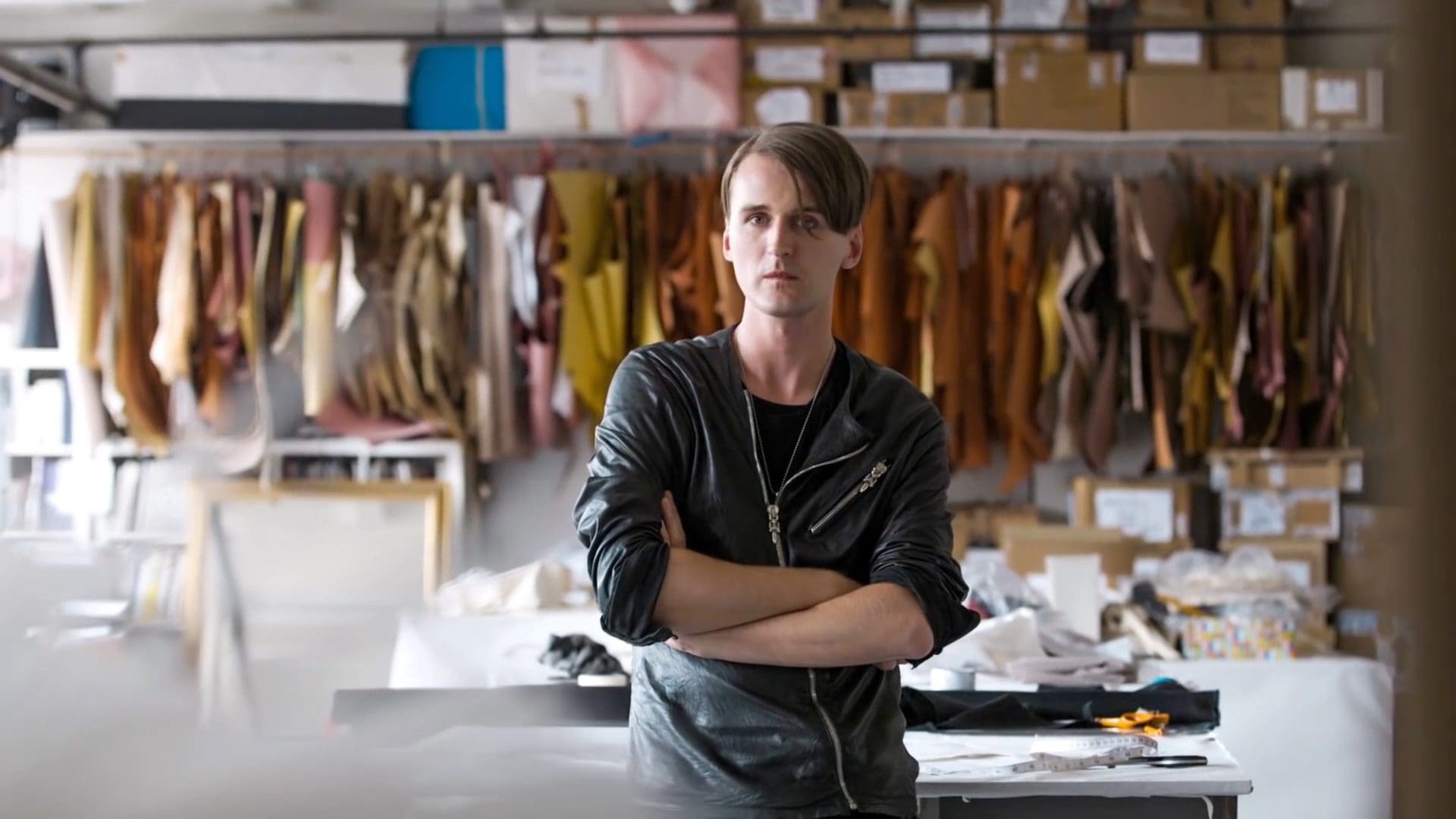 RIOT, NYC Creative Agency: Gareth Pugh, British fashion designer, standing in his studio surrounded by leather materials, showcasing his creative process for the Sunglass Hut collaboration. Gareth Pugh, British fashion designer, standing in his studio surrounded by leather materials, showcasing his creative process for the Sunglass Hut collaboration.