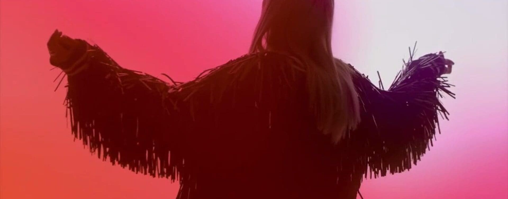 Sunglass Hut Start With The Shades – Fire Trend – Cailin Russo (Fiery Red Effect) Cailin Russo in a dramatic pose, surrounded by fiery red hues, representing the energetic and powerful Fire Trend for Sunglass Hut’s campaign.