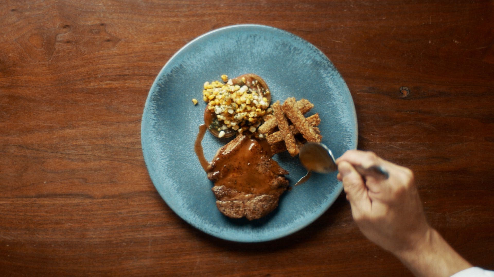 A plated dish featuring pork, oat fries, and corn, inspired by market trends and futures trading in TD Ameritrade’s Taste of the Futures.