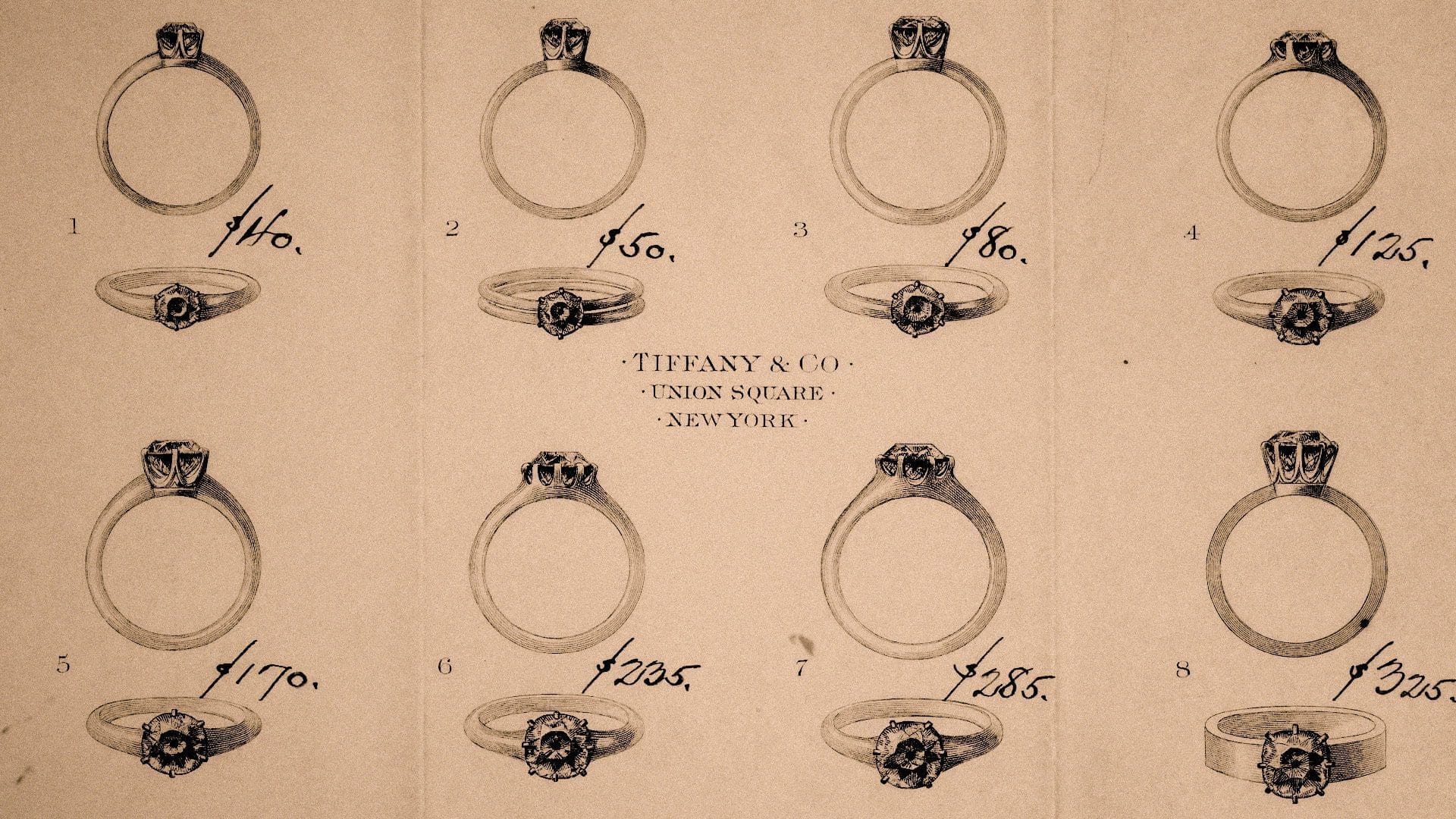 RIOT, NYC Creative Agency: Vintage Tiffany & Co. advertisement showcasing a selection of eight engagement rings with prices, illustrating the classic jewelry styles offered at their Union Square store in New York. Vintage Tiffany & Co. advertisement showcasing a selection of eight engagement rings with prices, illustrating the classic jewelry styles offered at their Union Square store in New York.