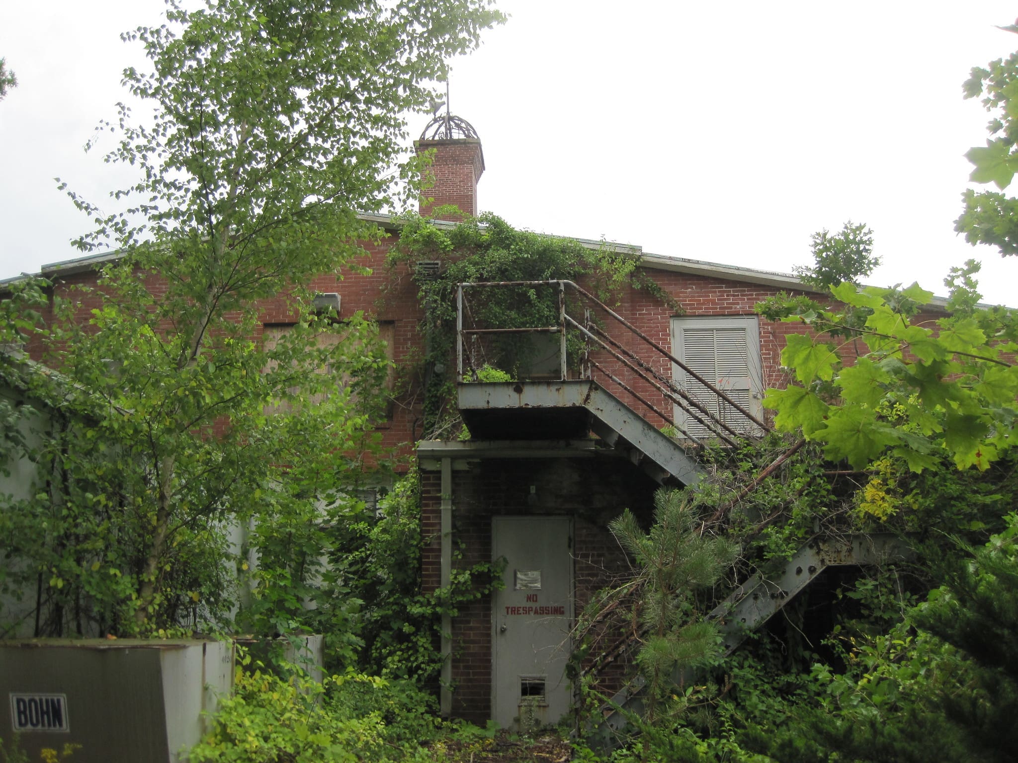 RIOT, NYC Creative Agency: A photograph of the overgrown and abandoned Wardenclyffe Tower site, where Tesla envisioned transmitting wireless energy. A photograph of the overgrown and abandoned Wardenclyffe Tower site, where Tesla envisioned transmitting wireless energy.