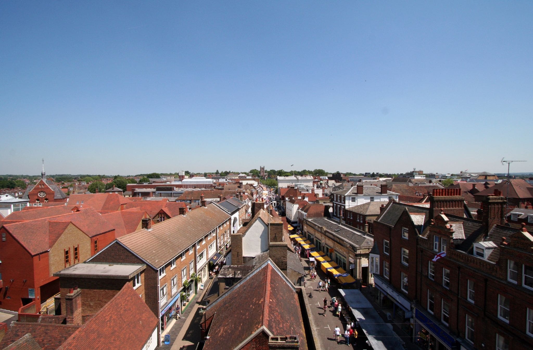 Aerial view of St Albans market from the Clock Tower, showcasing historic buildings and bustling market stalls.
