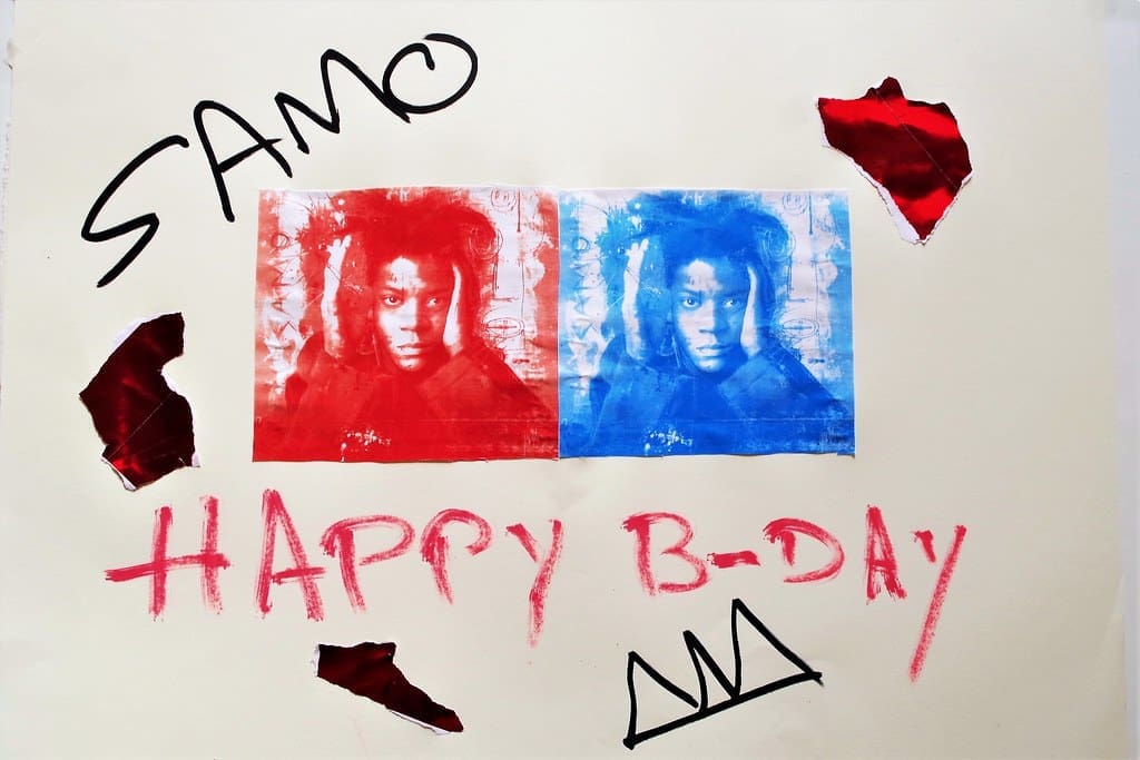 Artwork tribute to Jean-Michel Basquiat with SAMO graffiti, featuring red and blue portraits of Basquiat, text reading ‘Happy B-Day,’ and the SAMO crown symbol.