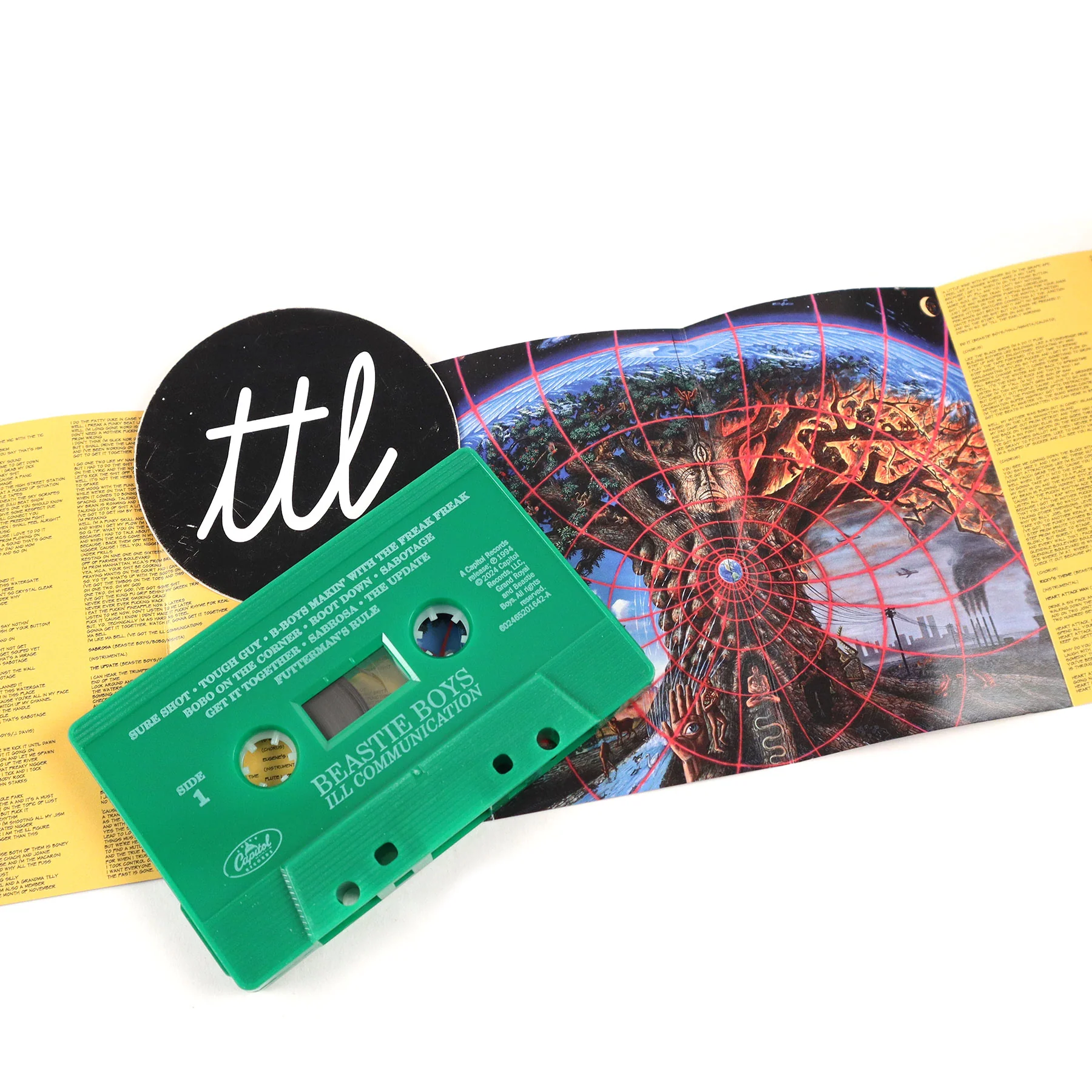 The interior of the Ill Communication cassette featuring Alex Grey’s artwork “Gaia” alongside song lyrics.