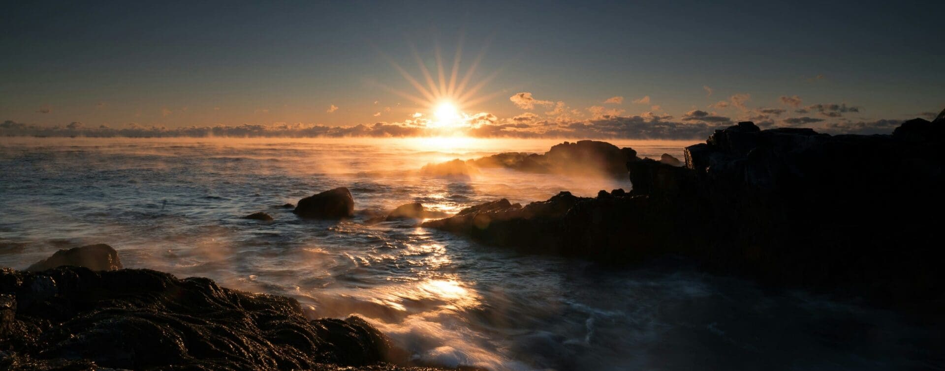 What Comes After Zero Sunrise over ocean waves crashing against a rocky shoreline