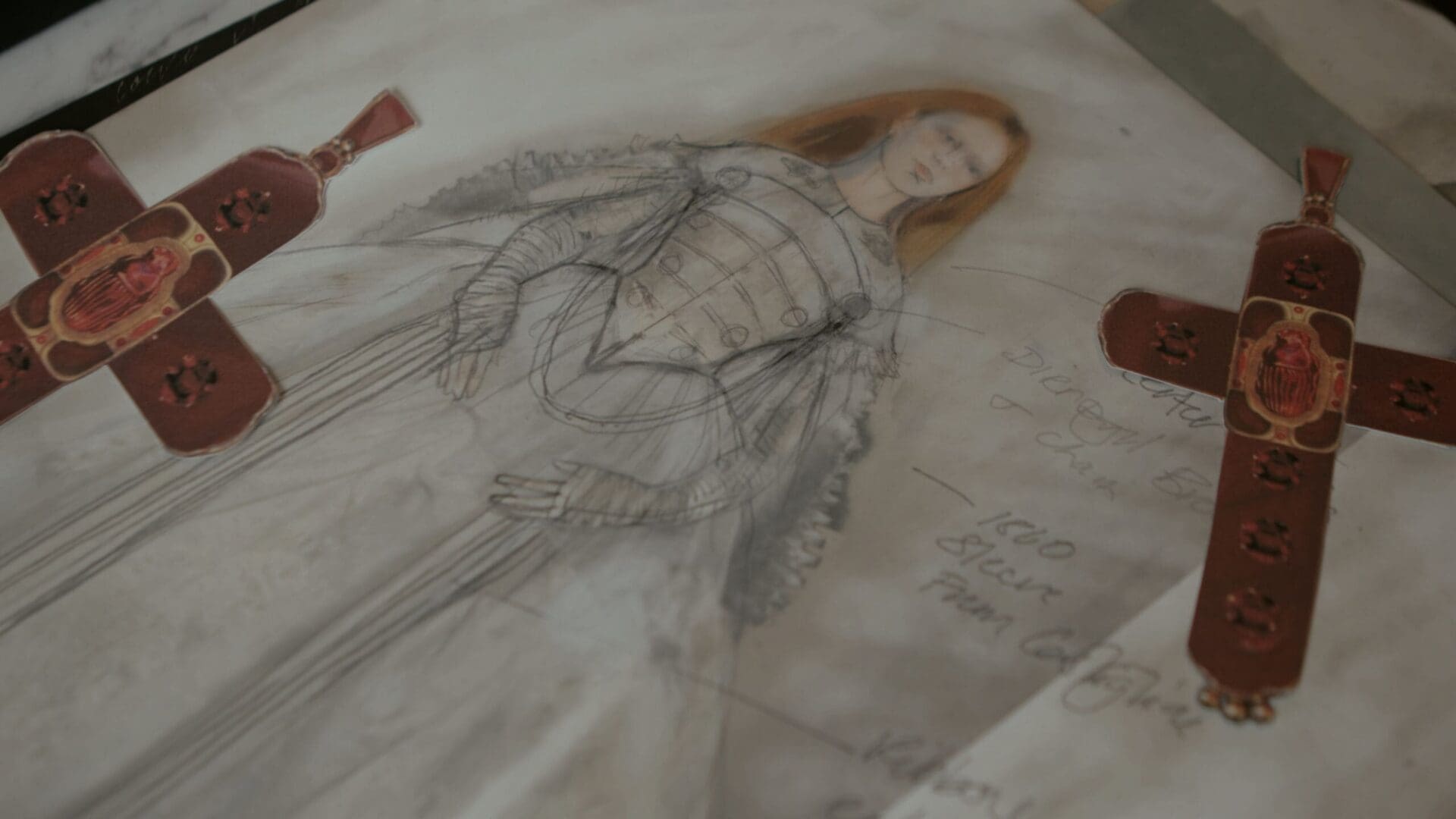 Elizabeth costume drawing with cross motif references pinned around it