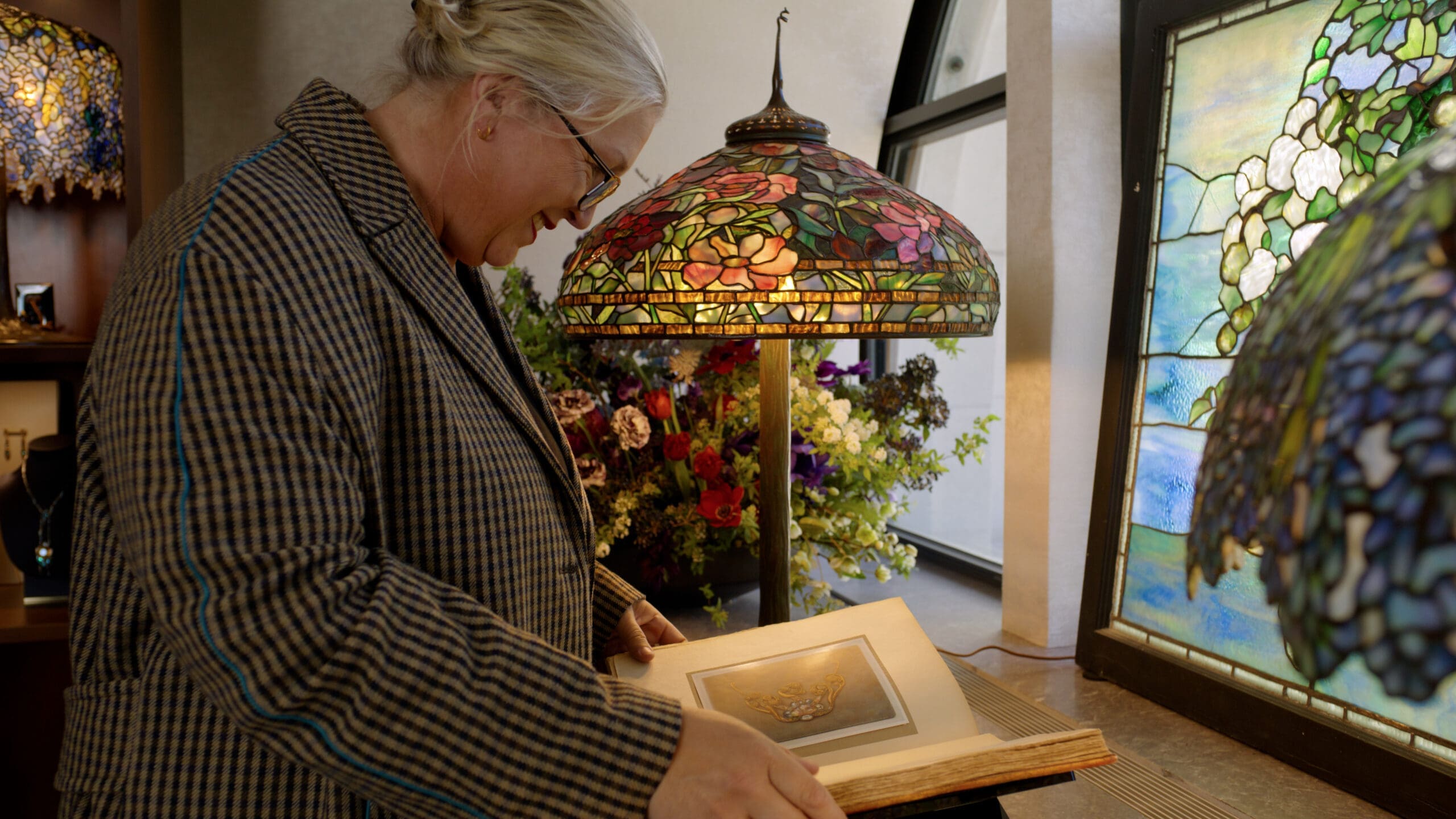 Kate Hawley with Tiffany lamps and reference materials