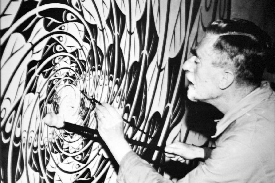 M.C. Escher working on a large artwork in his atelier, surrounded by intricate, swirling patterns.