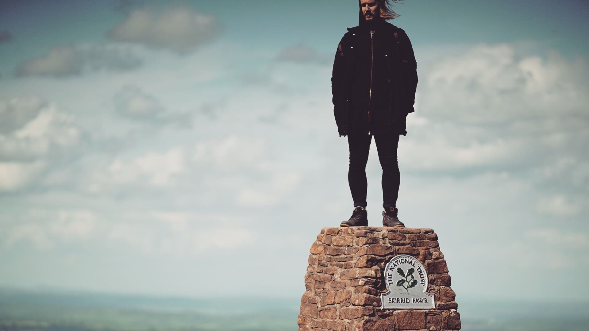 RIOT, NYC Creative Agency: MUG5 standing on top of Skirrid Fawr, capturing the spirit of adventure and creativity MUG5 standing on top of Skirrid Fawr, capturing the spirit of adventure and creativity