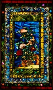 John La Farge’s stained glass panel, "Peonies Blown in the Wind" (1880), featuring vibrant peonies against a luminous blue and gold background. Image via Wikimedia Commons.