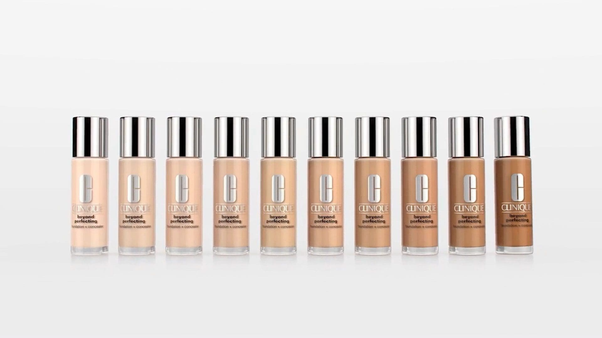 A lineup of Clinique Beyond Perfecting foundation and concealer bottles in various shades.