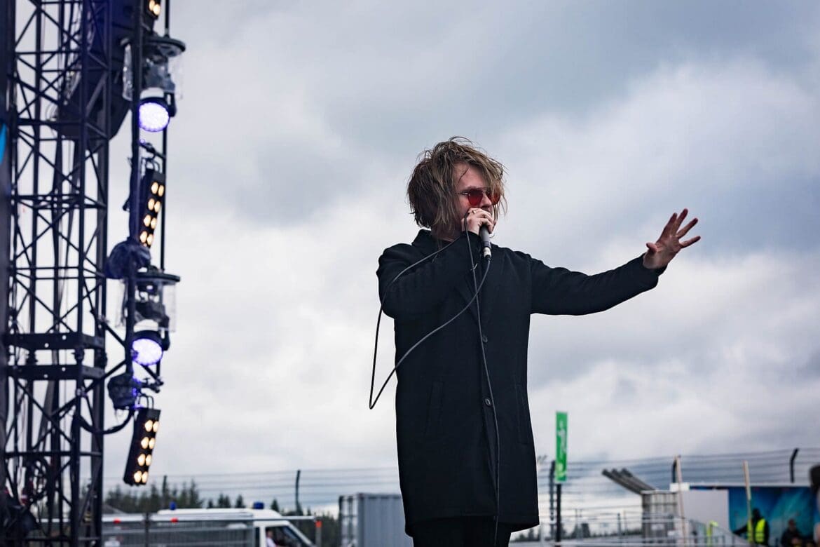 Rou Reynolds of Enter Shikari performing live at Rock am Ring 2018, holding a microphone with outstretched hand.
