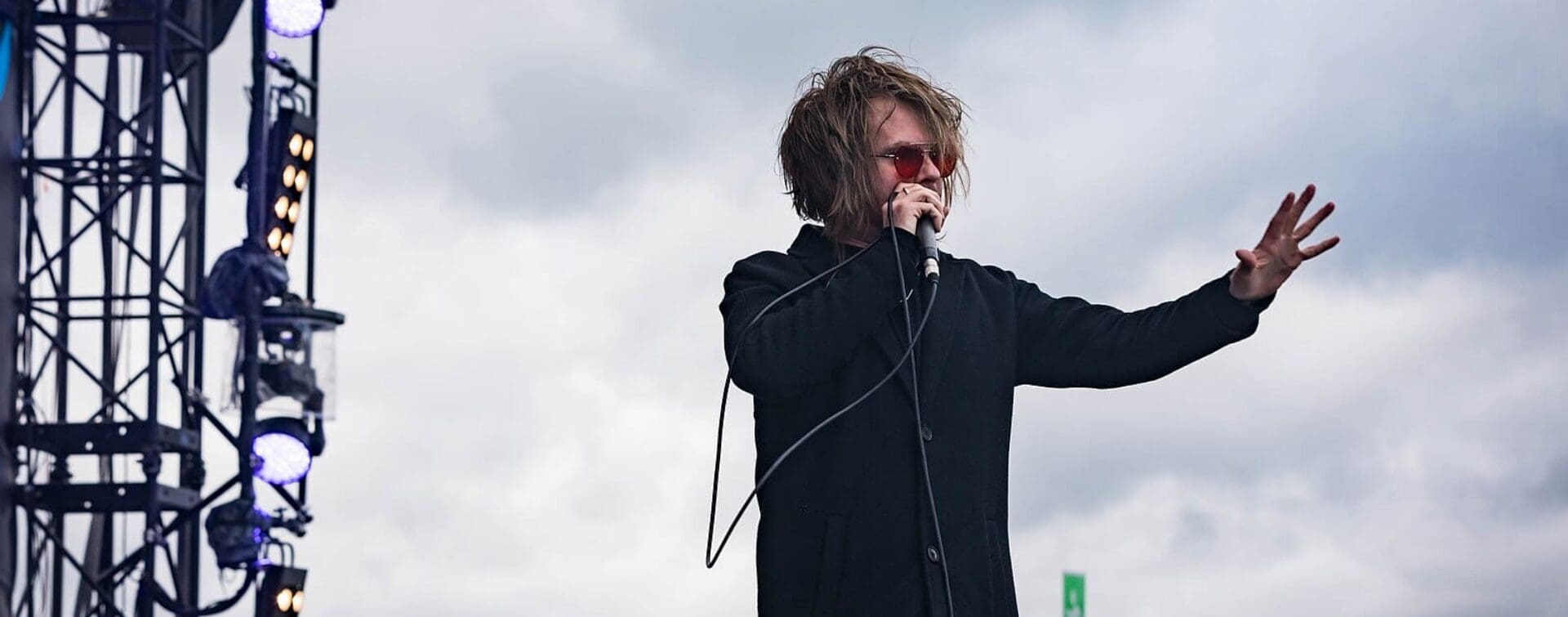 Rou Reynolds of Enter Shikari performing live at Rock am Ring 2018, holding a microphone with outstretched hand.