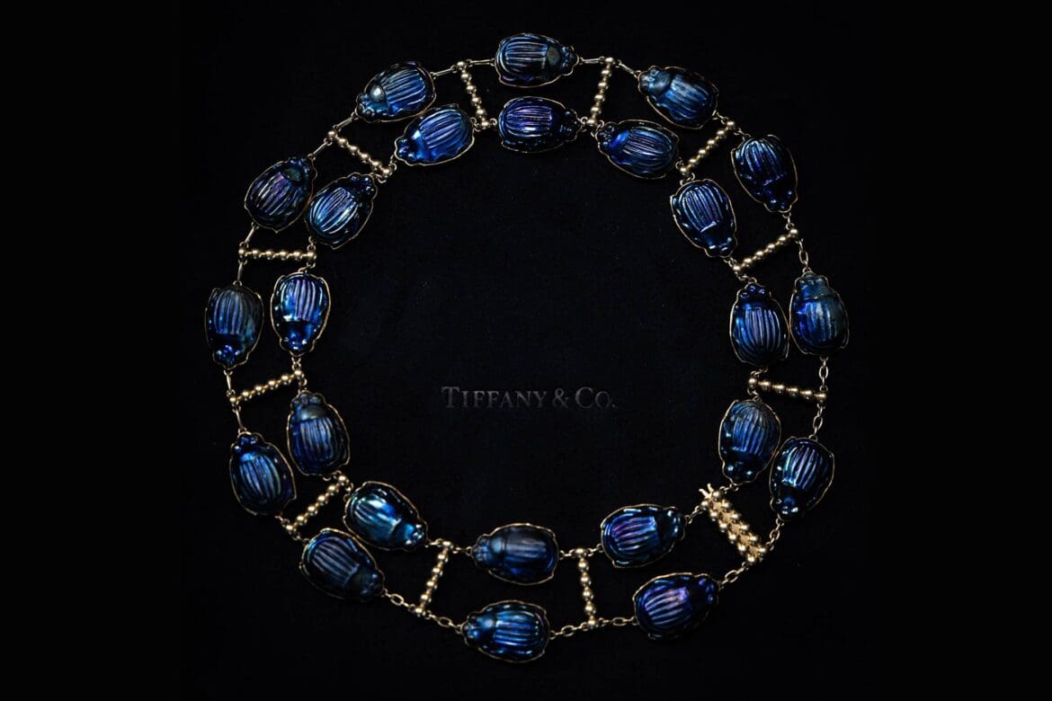 Close-up of an archival Tiffany scarab necklace on black velvet, captured for Tiffany x Frankenstein by RIOT.