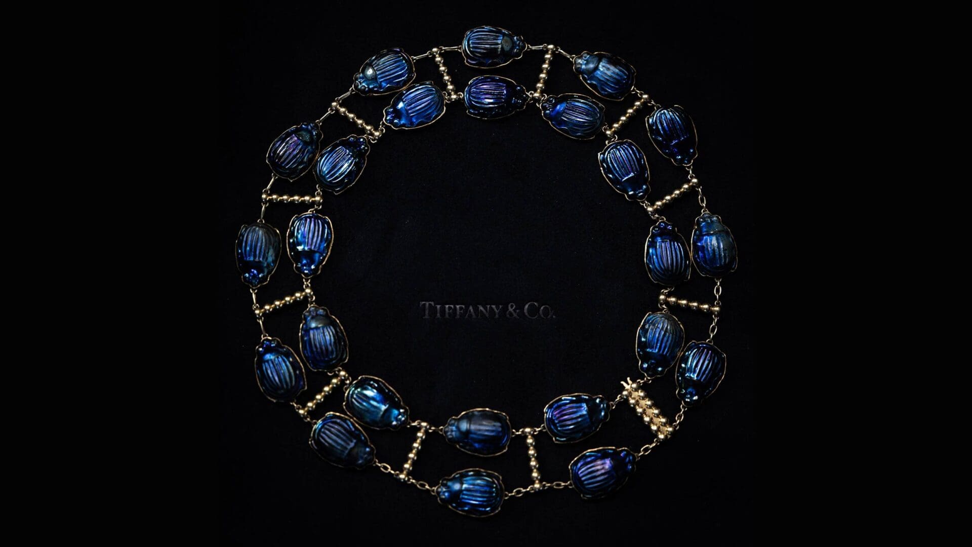 Tiffany x Frankenstein — Archival Scarab Necklace (RIOT Capture) Close-up of an archival Tiffany scarab necklace on black velvet, captured for Tiffany x Frankenstein by RIOT.