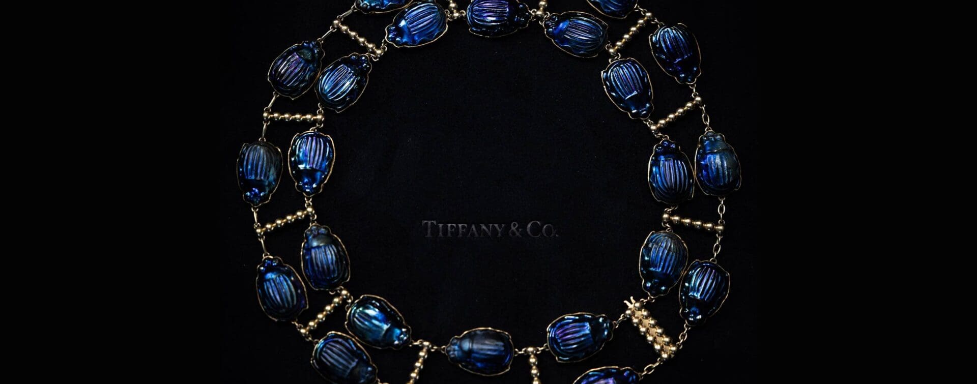 Tiffany x Frankenstein — Archival Scarab Necklace (RIOT Capture) Close-up of an archival Tiffany scarab necklace on black velvet, captured for Tiffany x Frankenstein by RIOT.