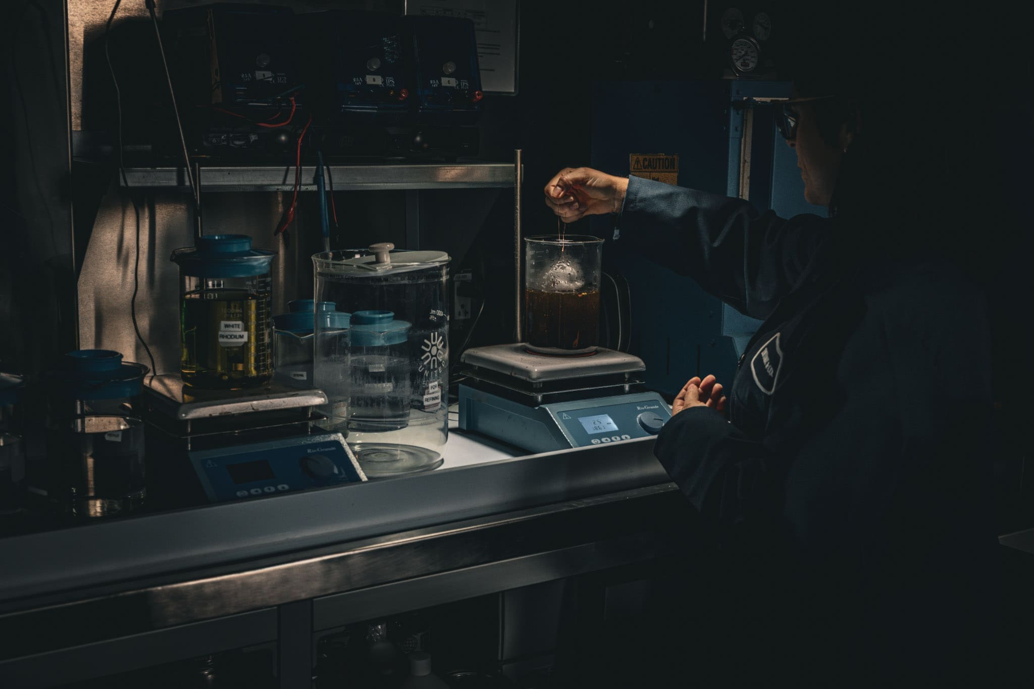 RIOT, NYC Creative Agency: A Tiffany craftsperson works in a dimly lit lab, stirring a beaker in a scene reminiscent of Frankenstein’s workshop, captured for Tiffany x Frankenstein by RIOT. A Tiffany craftsperson works in a dimly lit lab, stirring a beaker in a scene reminiscent of Frankenstein’s workshop, captured for Tiffany x Frankenstein by RIOT.