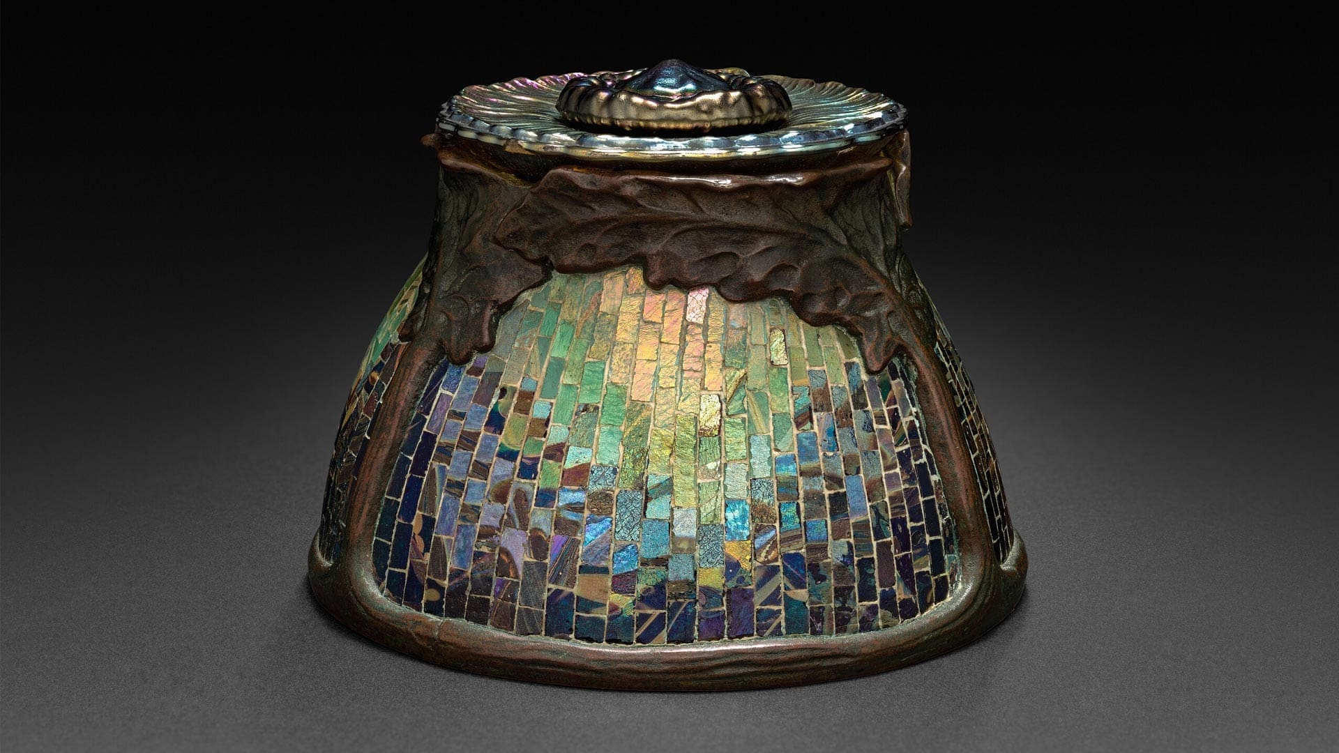 RIOT, NYC Creative Agency: Tiffany Studios inkwell designed by Clara Wolcott Driscoll, featuring iridescent mosaic glass and bronze oak leaves. Image via Wikimedia Commons. Tiffany Studios inkwell designed by Clara Wolcott Driscoll, featuring iridescent mosaic glass and bronze oak leaves. Image via Wikimedia Commons.