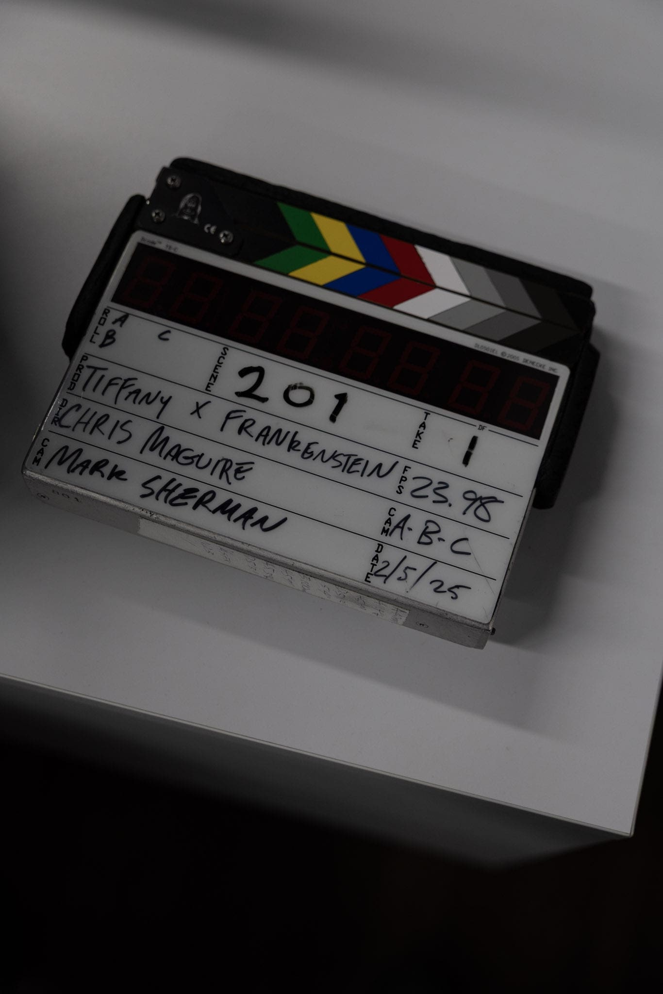 Film clapperboard labeled “Tiffany x Frankenstein,” directed by Chris Maguire with cinematography by Mark Sherman, captured behind the scenes by RIOT.